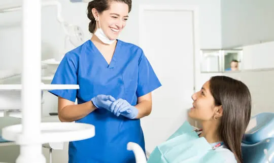 dental assistant explaining options for orthodontics