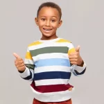 young boy giving thumbs up